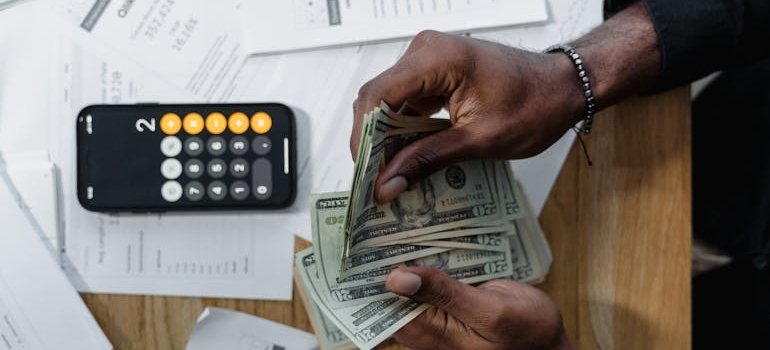 A person counting dollar bills