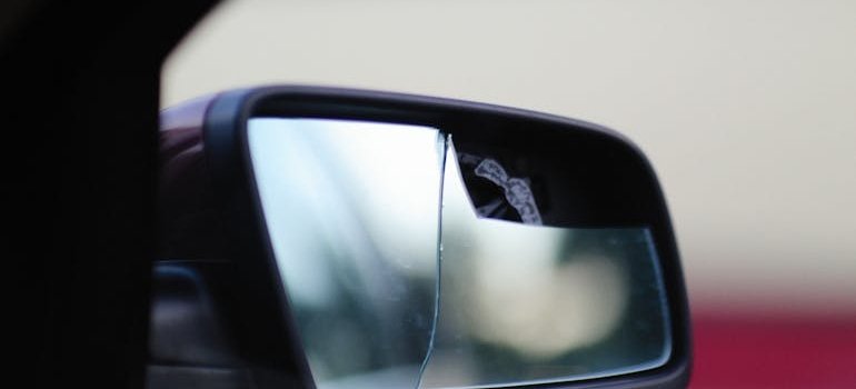 Broken side mirror of the car as one of the reasons NYC residents choose vehicle storage