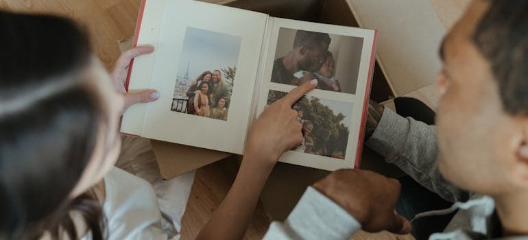 A couple looking at the photos and talking about items that should always be stored in climate controlled units.