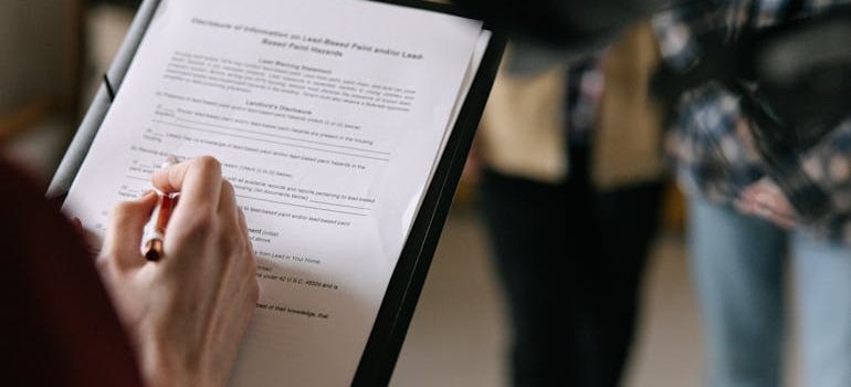 A person holding a document with NYC lease clauses that affect storage plans