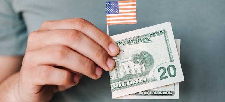 A person holding a dollar bill