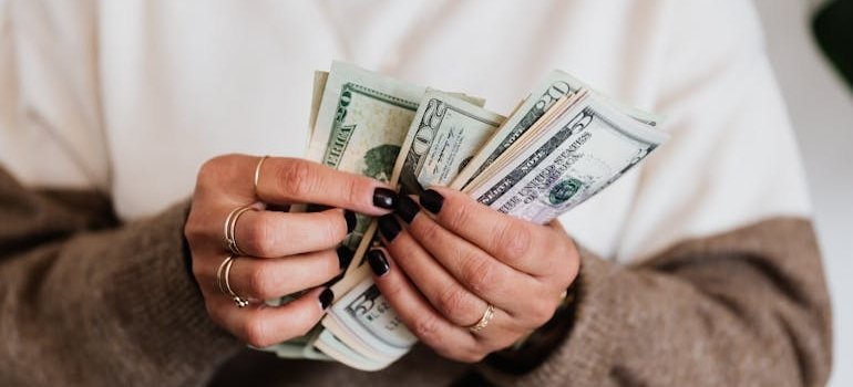 A person counting dollar bills