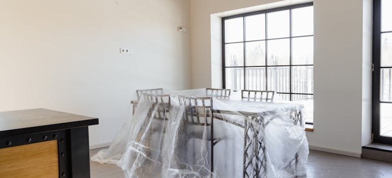 A covered table with packing materials for storing furniture in NYC