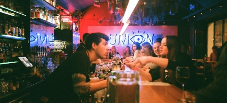 People in the bar in one of the Manhattan neighborhoods ranked by lifestyle