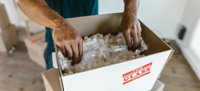 A man packing glasses
