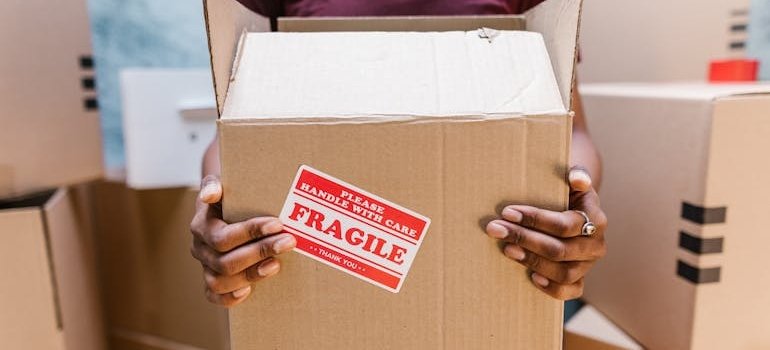 A man holding a box and thinking what to leave for a pickup crew