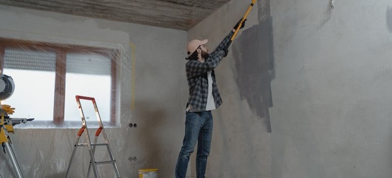 A person painting wall