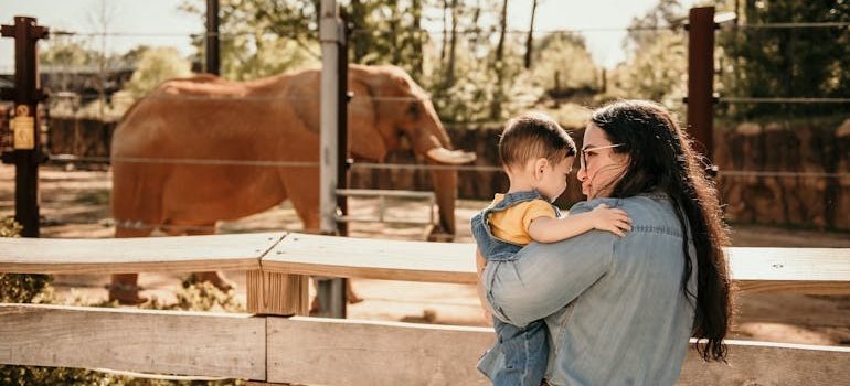 A woman and the kids in the zoo, enjoying some of the things to do in the Bronx after moving from Manhattan