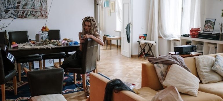 A woman sitting on the chair and thinking about hosting Easter brunch in a small NYC apartment