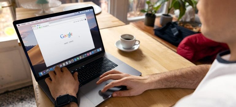 A person using a laptop to find a storage unit security checklist online