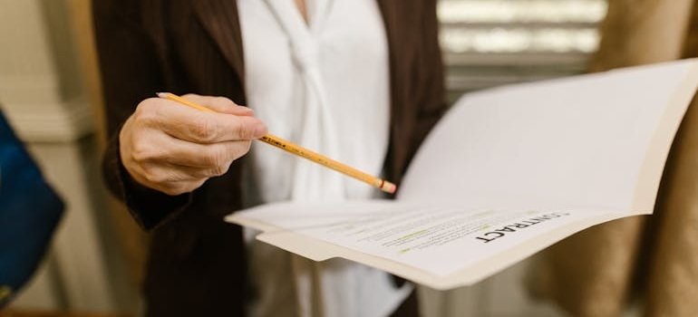A person who is trying to find affordable storage units near you reading a contract