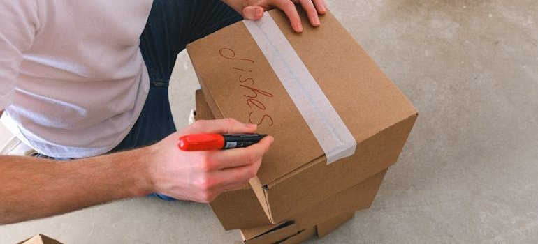 A man labeling a box