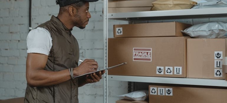 A man making a list of what fits in a 10x20 storage unit