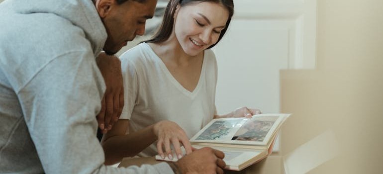 A couple looking at the photos and talking about what NYC residents should store instead of throwing away