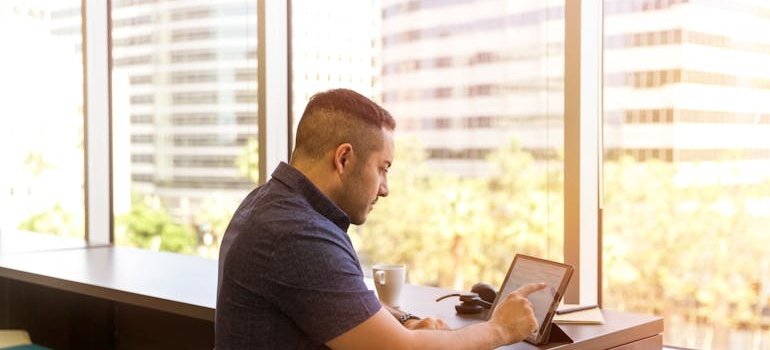 A man working in the cafe in one of the Manhattan neighborhoods for remote workers