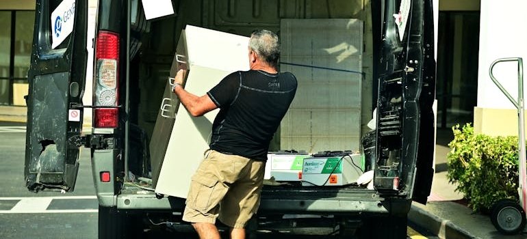 A man unloading belongings and moving into a luxury building in Manhattan