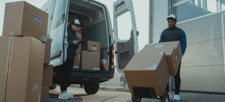 Twp people loading a van and talking about storage options for NYC renters between leases