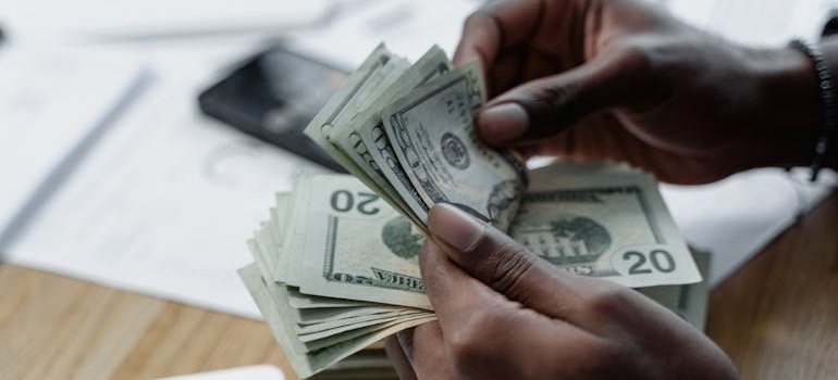 A person counting dollar bills
