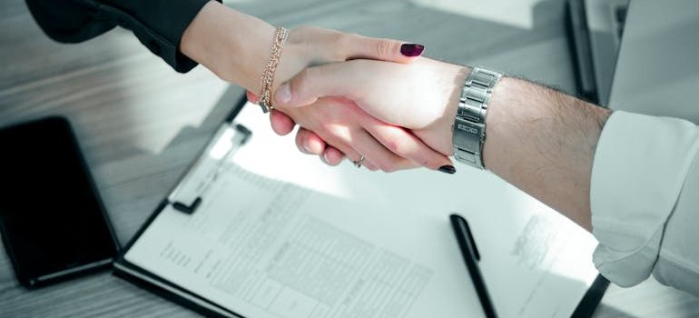 Two people who are sharing storage space in NYC shaking hands