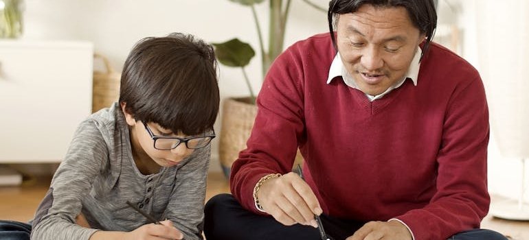 Two people writing on the paper