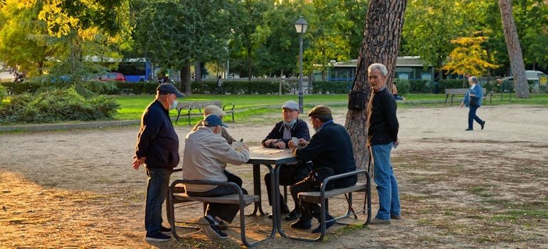 People in the park talking about why NYC residents are moving to Mott Haven