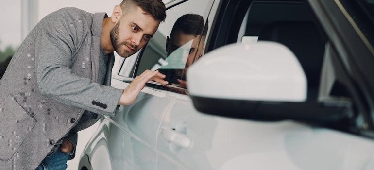 A man inspecting a car before putting your vehicle in storage