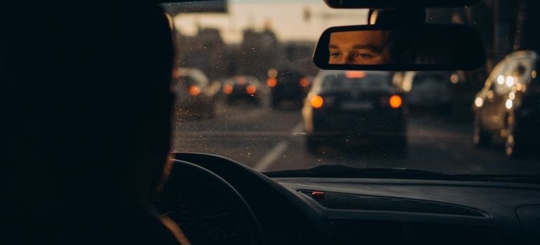 A person driving a car and thinking car storage can reduce parking stress in Manhattan
