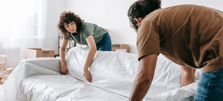 A couple talking about getting a storage unit instead of a bigger apartment