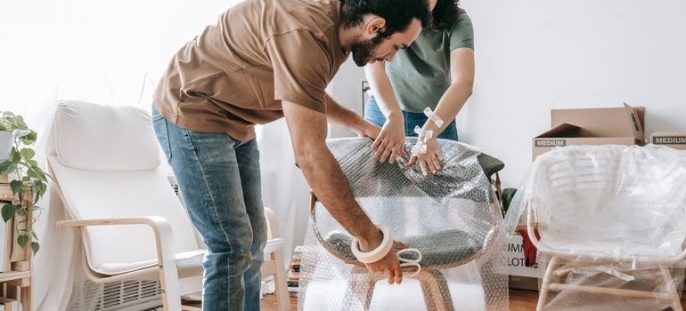 A couple packing furniture