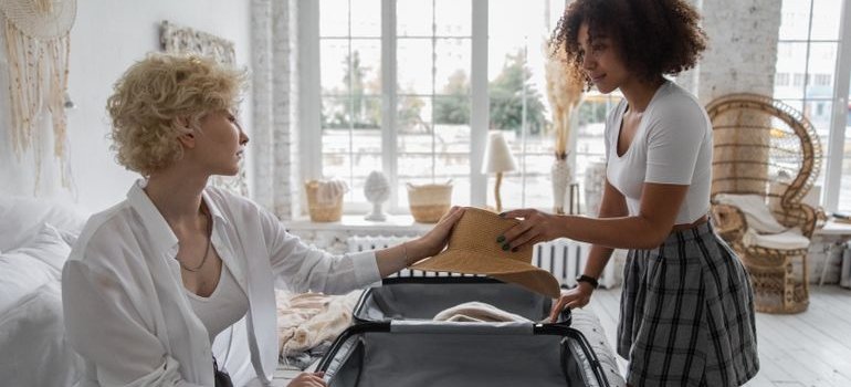 Two women packing items every student should store