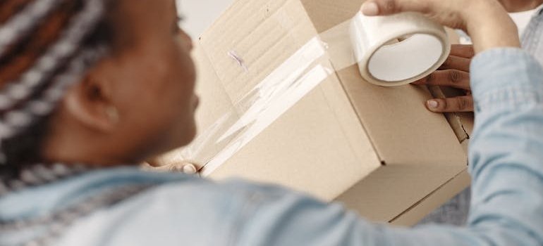 A person packing a box