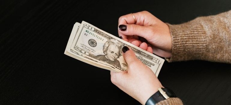 A person holding dollar bills