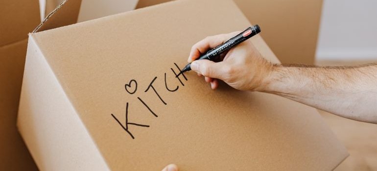 A woman labeling a box