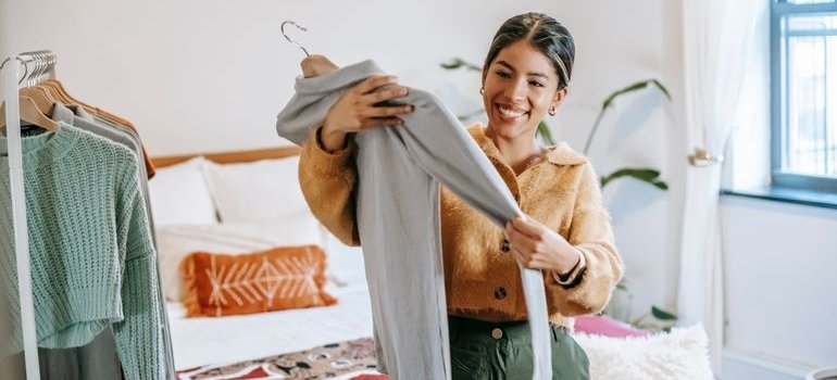 A woman holding a shirt