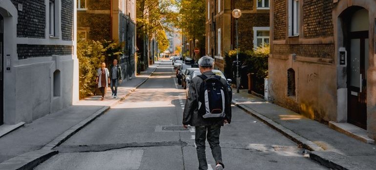 A person walking on the street and thinking about Mott Haven vs Port Morris