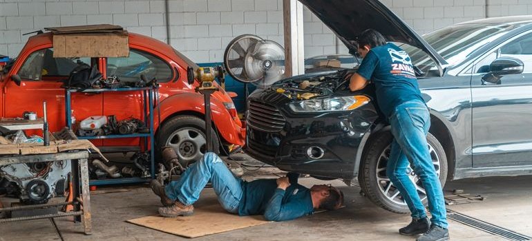 Workers repairing the car