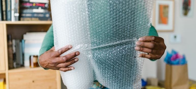 A person holding one of the best packing materials for long term storage
