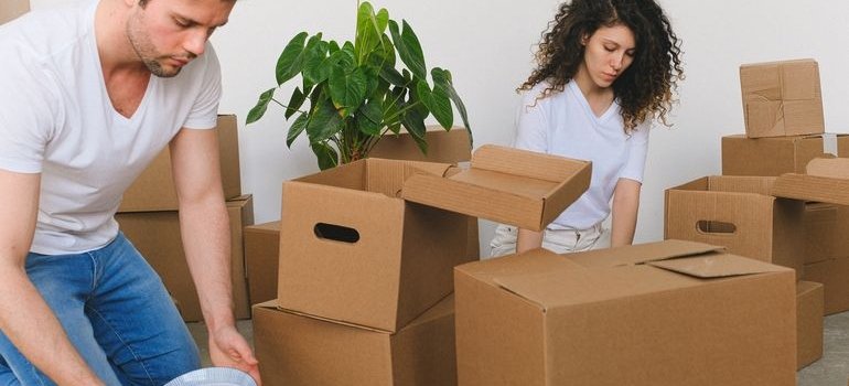 Two people packing and talking about the cost of living in Wakefield