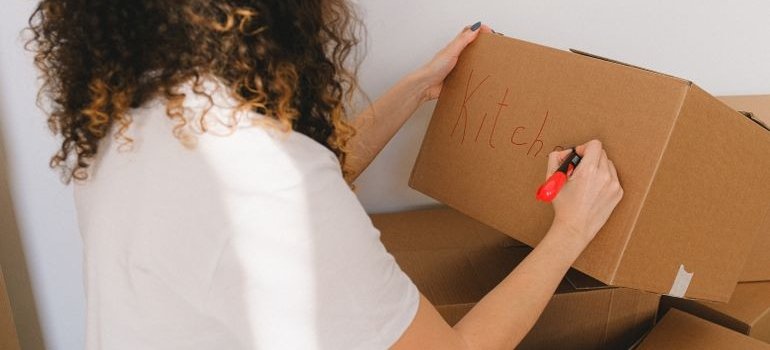 A person labeling a box
