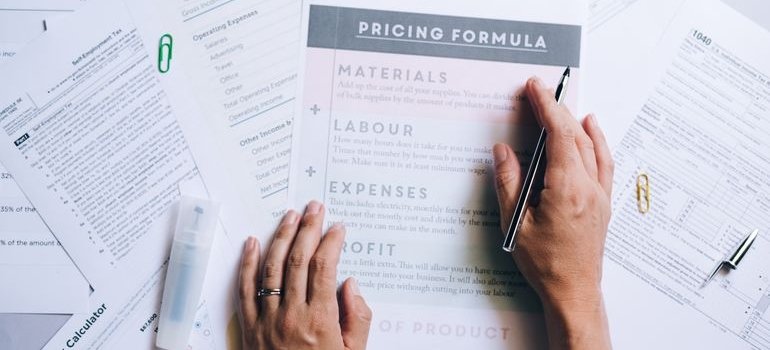 A person reading a document with renovation tips for Bronx homeowners