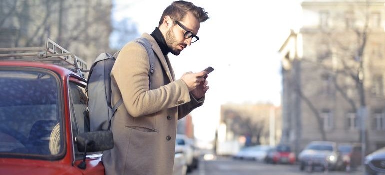 A person using a phone to find out information about the vehicle storage NYC