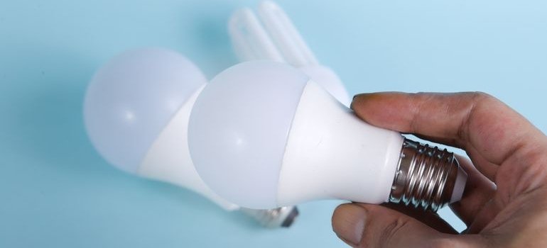 A person holding a bulb