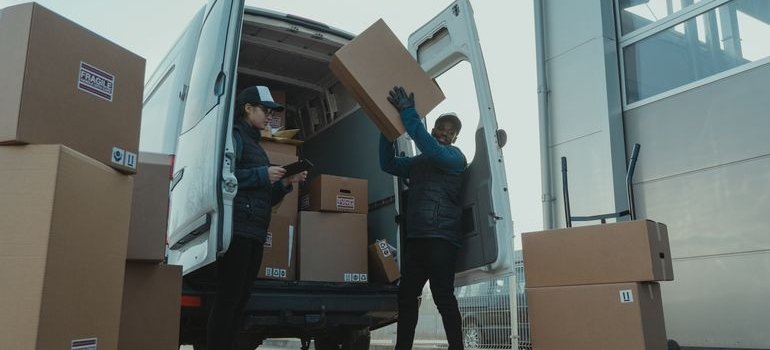 Two men loading moving van